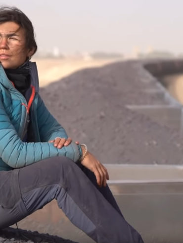 girl riding coal train in africa