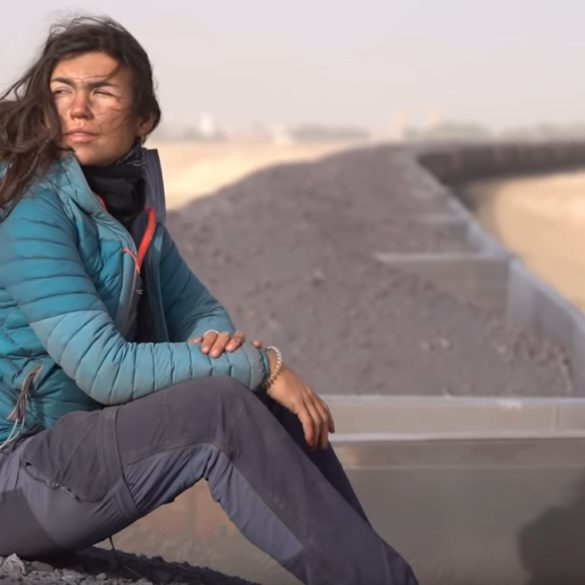 girl riding coal train in africa