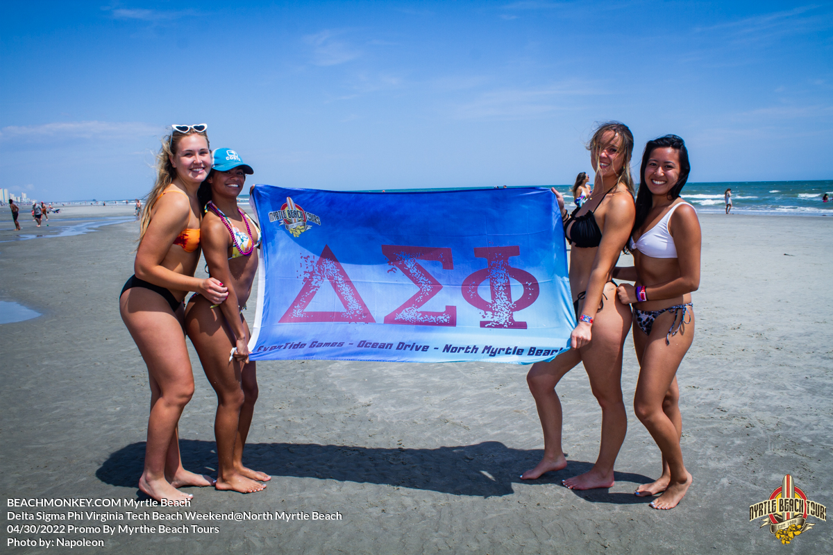 four hot girls with flag Delta Sigma Phi Virginia Tech Fraternity Beach Weekend in North Myrtle Beach, SC USA sponsored by Myrtlebeachtours.com April 30th 2022 Photos by Napoleon