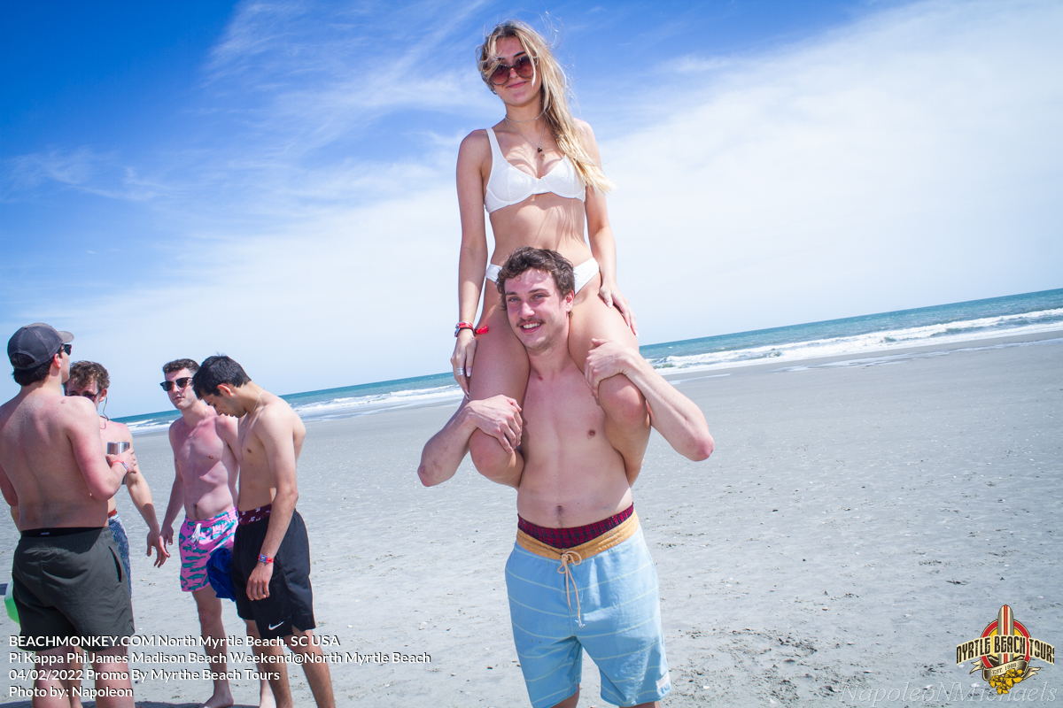sorority girl in bikini riding on shoulders Pi Kappa Phi James Madison University Fraternity Beach Weekend in North Myrtle Beach, SC USA sponsored by Myrtlebeachtours.com April 2nd 2022 Photos by Napoleon