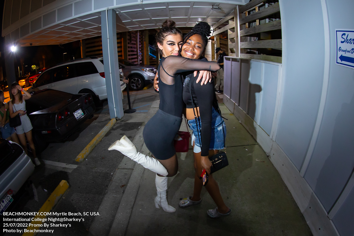 two hot girls hugging at sharkeys bar in Myrtle Beach, SC on international college night in July 25 2022