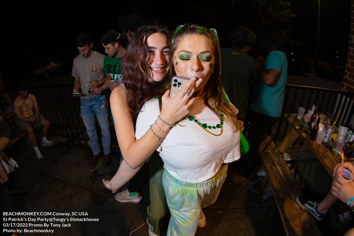 girl smoking from other girl at Tongys Shmackhouse for St Patricks Day on march 17 2022 in Conway, SC USA photos  by Myrtle Beach photographer Beachmonkey