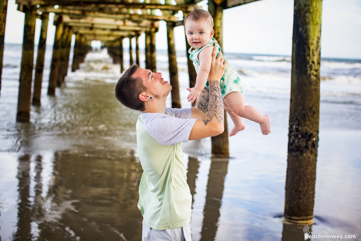father and baby son A family Beach photo shoot in North Myrtle Beach, SC with Alisha's family by Beachmonkey of beachmonkey photography, a family photographer on July 19th 2022