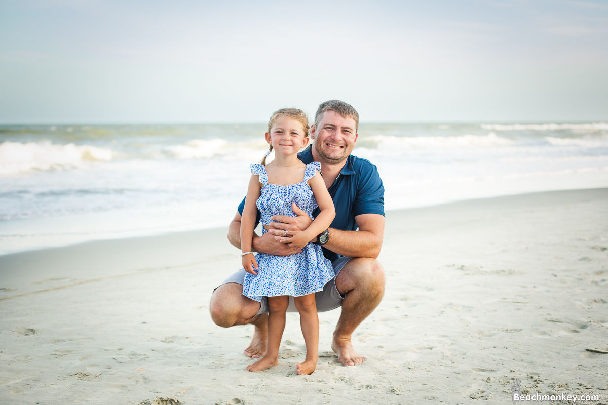 Child with father A family photo shoot in Garden City, SC at the Garden City Pier with Deanna's family by Slava of beachmonkey photography, a family photographer July 2022