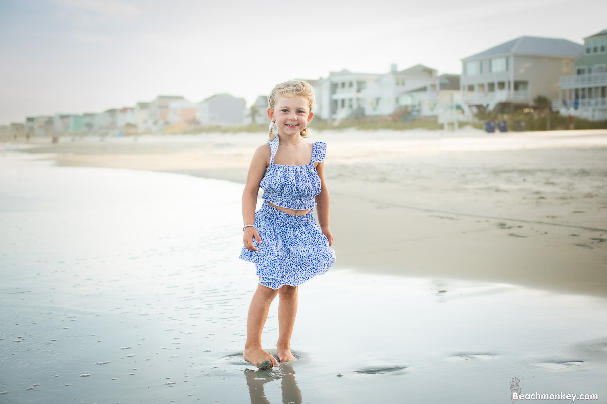 child on beach at A family photo shoot in Garden City, SC at the Garden City Pier with Deanna's family by Slava of beachmonkey photography, a family photographer July 2022