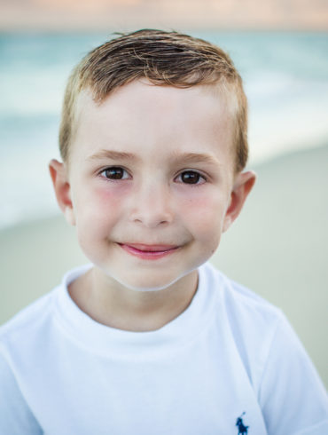 Little Boy smiling A family Beach photo shoot in Myrtle Beach, SC USA with Irena's family by Slava of beachmonkey photography, a family photographer on August 6th 2022