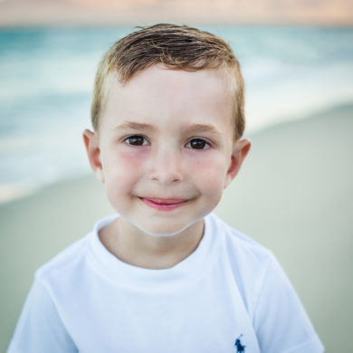 Little Boy smiling A family Beach photo shoot in Myrtle Beach, SC USA with Irena's family by Slava of beachmonkey photography, a family photographer on August 6th 2022