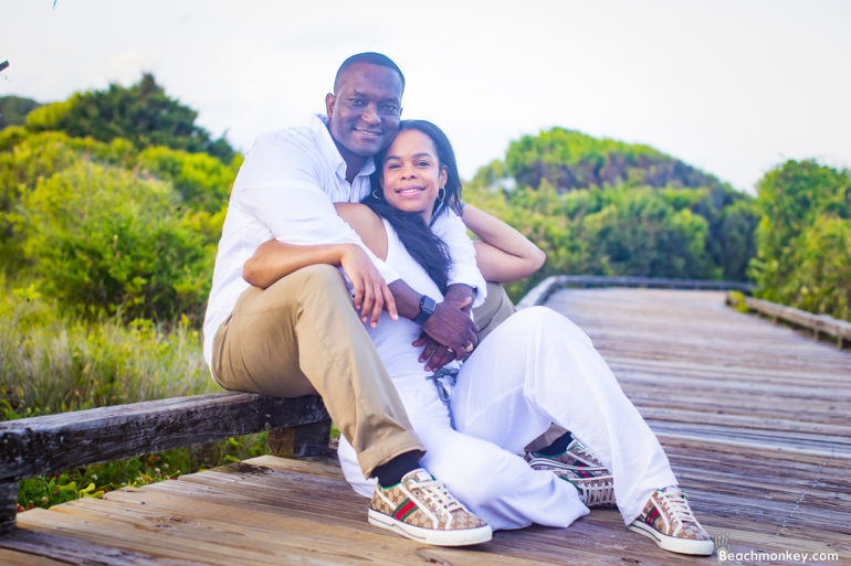 a couple cuddling A family Beach photo shoot in Myrtle Beach, SC with Jasmine's family by Beachmonkey of beachmonkey photography, a family photographer on July 21st 2022