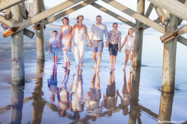 A family photo shoot in Myrtle Beach, SC at Apache Pier in Myrtle Beach with Jonathan's family by beachmonkey photography, a family photographer in July 2022