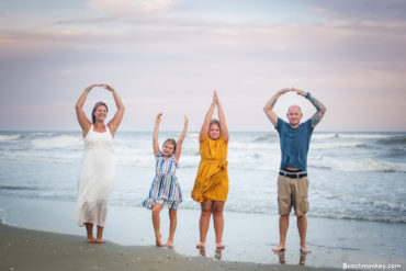 spelling out O H I O A family Beach photo shoot in North Myrtle Beach, SC with Kristen's family by Slava of beachmonkey photography, a family photographer on July 26th 2022