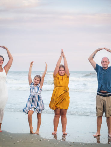 spelling out O H I O A family Beach photo shoot in North Myrtle Beach, SC with Kristen's family by Slava of beachmonkey photography, a family photographer on July 26th 2022