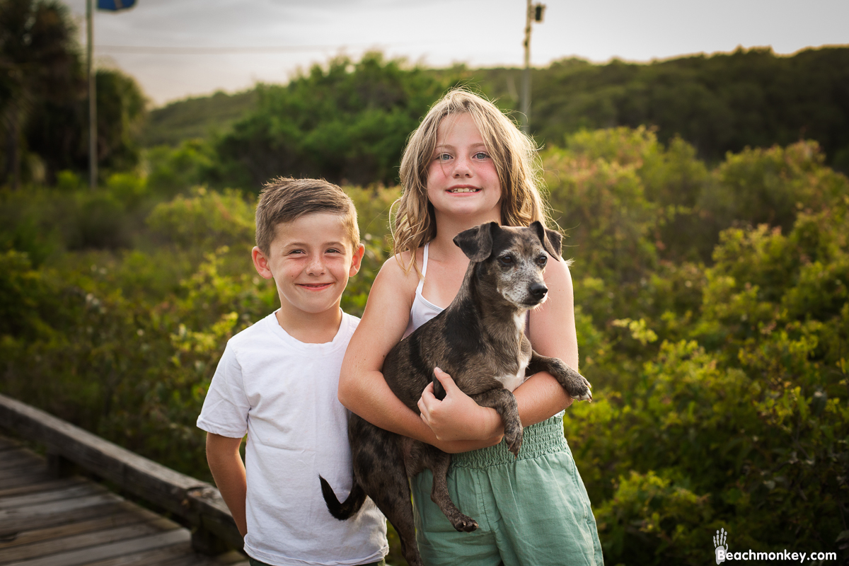 Two children and a dog at A family photo shoot in Myrtle Beach, SC at Myrtle Beach State Park with Larry's family by Slava of beachmonkey photography, a family photographer July 2022