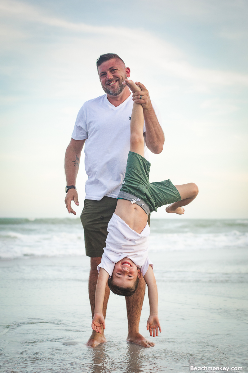 upside down father and son at A family photo shoot in Myrtle Beach, SC at Myrtle Beach State Park with Larry's family by Slava of beachmonkey photography, a family photographer July 2022