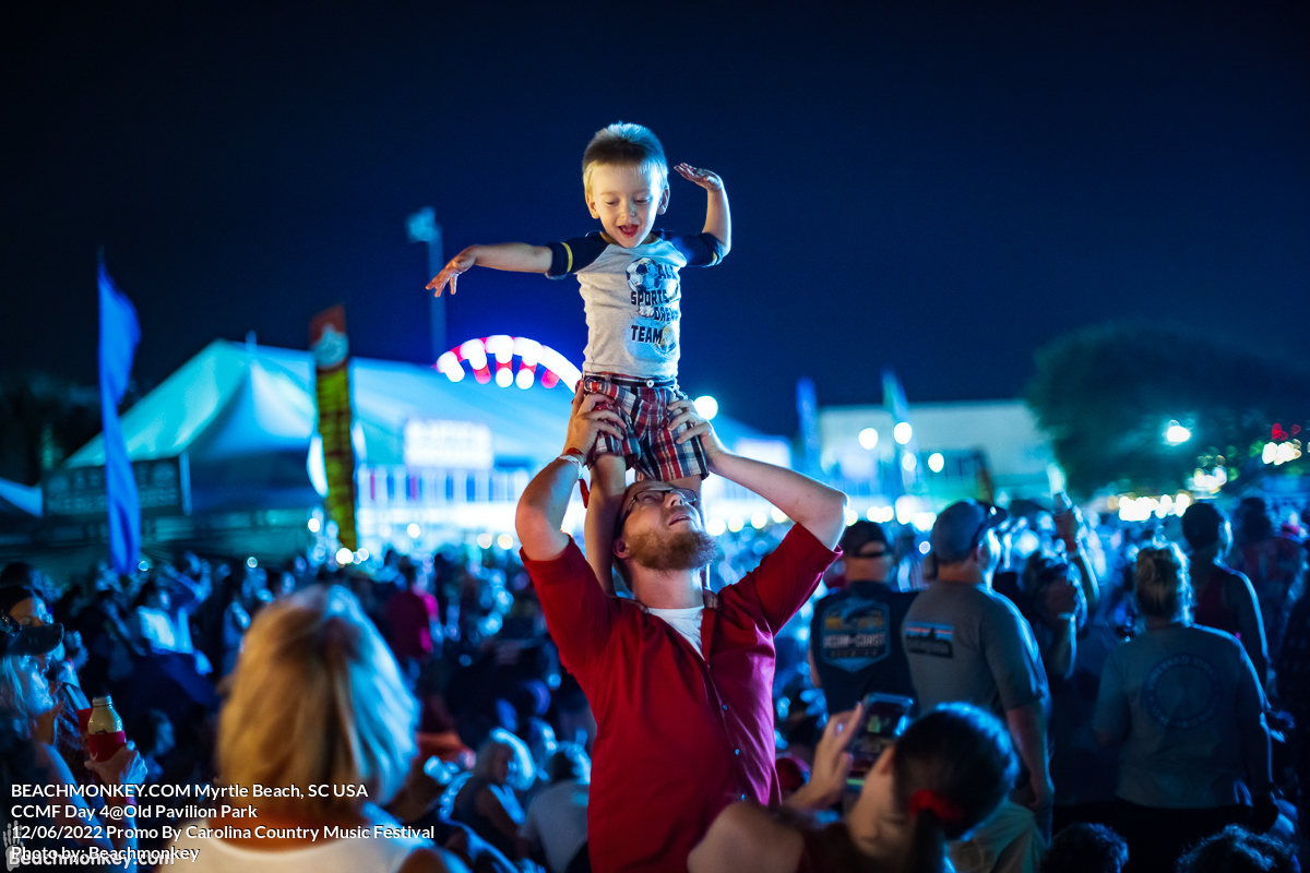 small boy on family shoulders at Carolina Country Music Festival Day Four June 12th, 2022 in Myrtle Beach, SC USA photos by Myrtle Beach photographer Beachmonkey