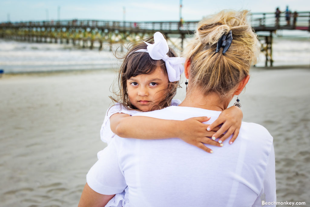 family beach photos small child in grandmothers arms at cherry grove pier in North Myrtle Beach, SC photo by Beachmonkey photography