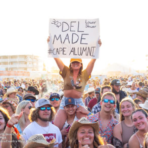 girl holding sign on shoulders in crowd at Carolina Country Music Festival Day three June 11th, 2022 in Myrtle Beach, SC USA photos by Myrtle Beach photographer Beachmonkey