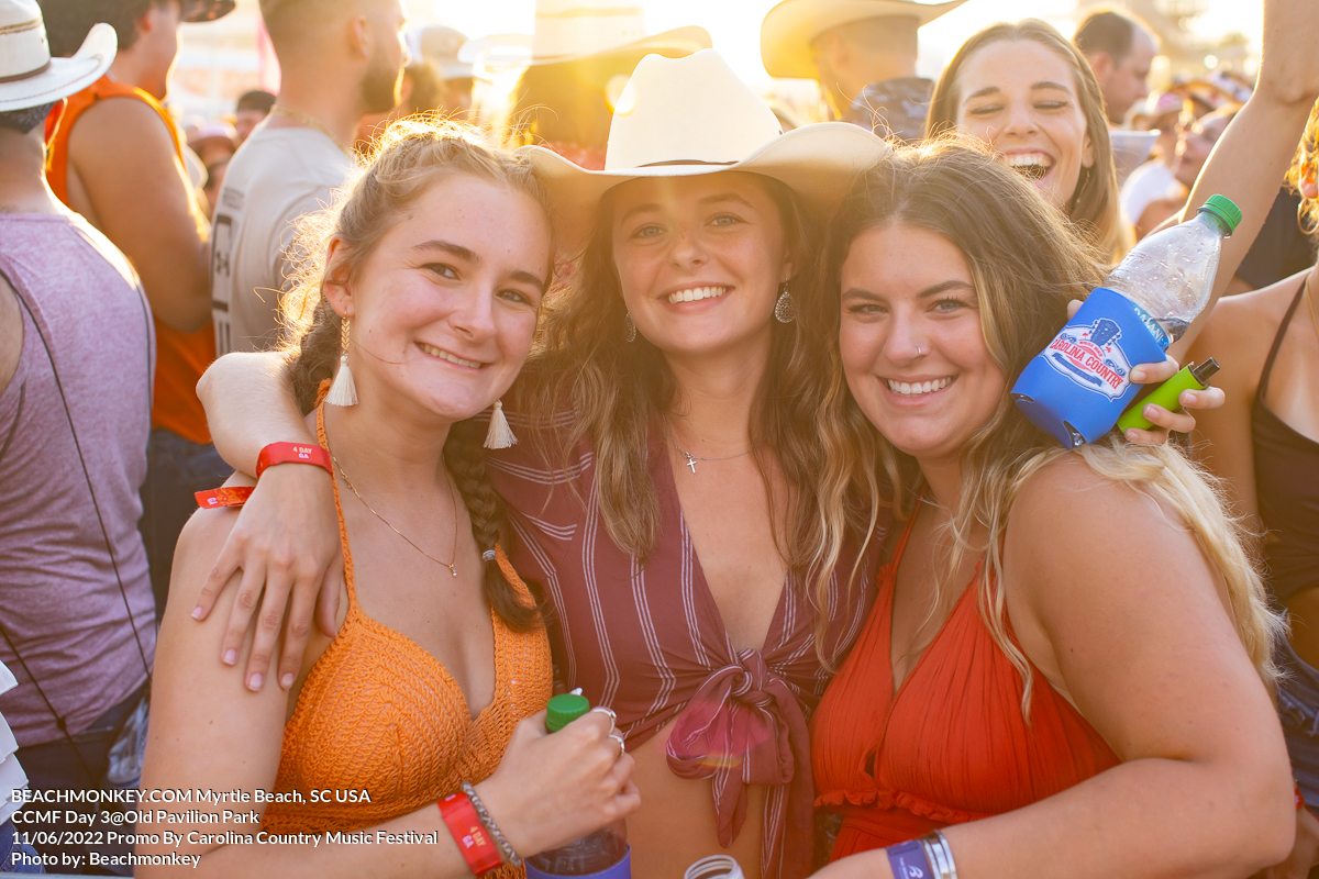 three beautiful girls in sunset lighting at Carolina Country Music Festival Day three June 11th, 2022 in Myrtle Beach, SC USA photos by Myrtle Beach photographer Beachmonkey