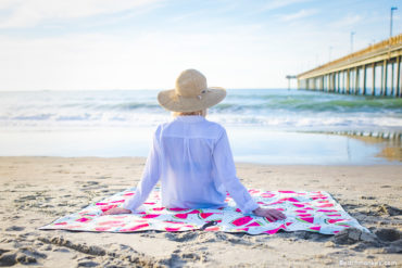 girl on watermelon towel watching waves A Branding and Lifestyle photo shoot in Myrtle Beach, SC with Solem Towel by Beachmonkey of beachmonkey photography, a Myrtle Beach photographer, Aug 14th 2022