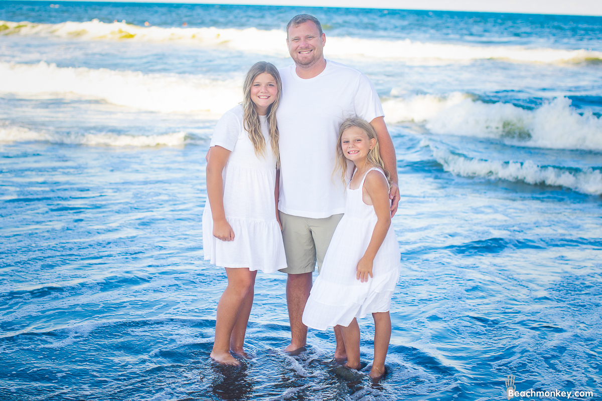 dad and daughters A family Beach photo shoot in Myrtle Beach, SC with Cassies's family by Beachmonkey of beachmonkey photography, a family photographer on July 16th 2022