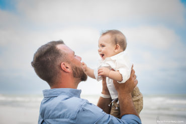 Baby and father A family Beach photo shoot in North Myrtle Beach, SC with Ashley's family by Slava of beachmonkey photography, a family photographer on July 7th 2022