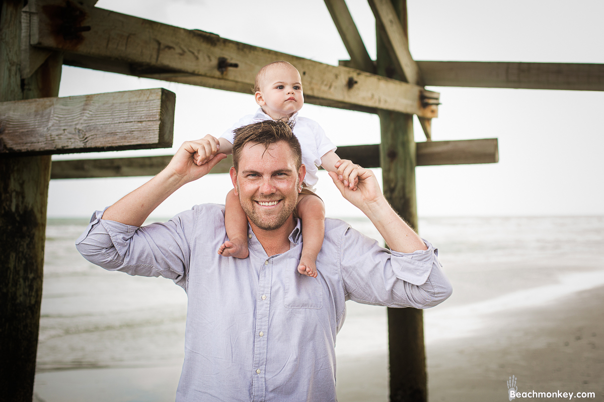 father and baby A family Beach photo shoot in North Myrtle Beach, SC with Ashley's family by Slava of beachmonkey photography, a family photographer on July 7th 2022