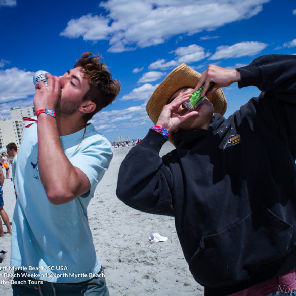 two guys shot gunning beer Delta Sigma Pi Virginia Tech Fraternity Beach Weekend in North Myrtle Beach, SC USA sponsored by Myrtlebeachtours.com April 9th 2022 Photos by Napoleon