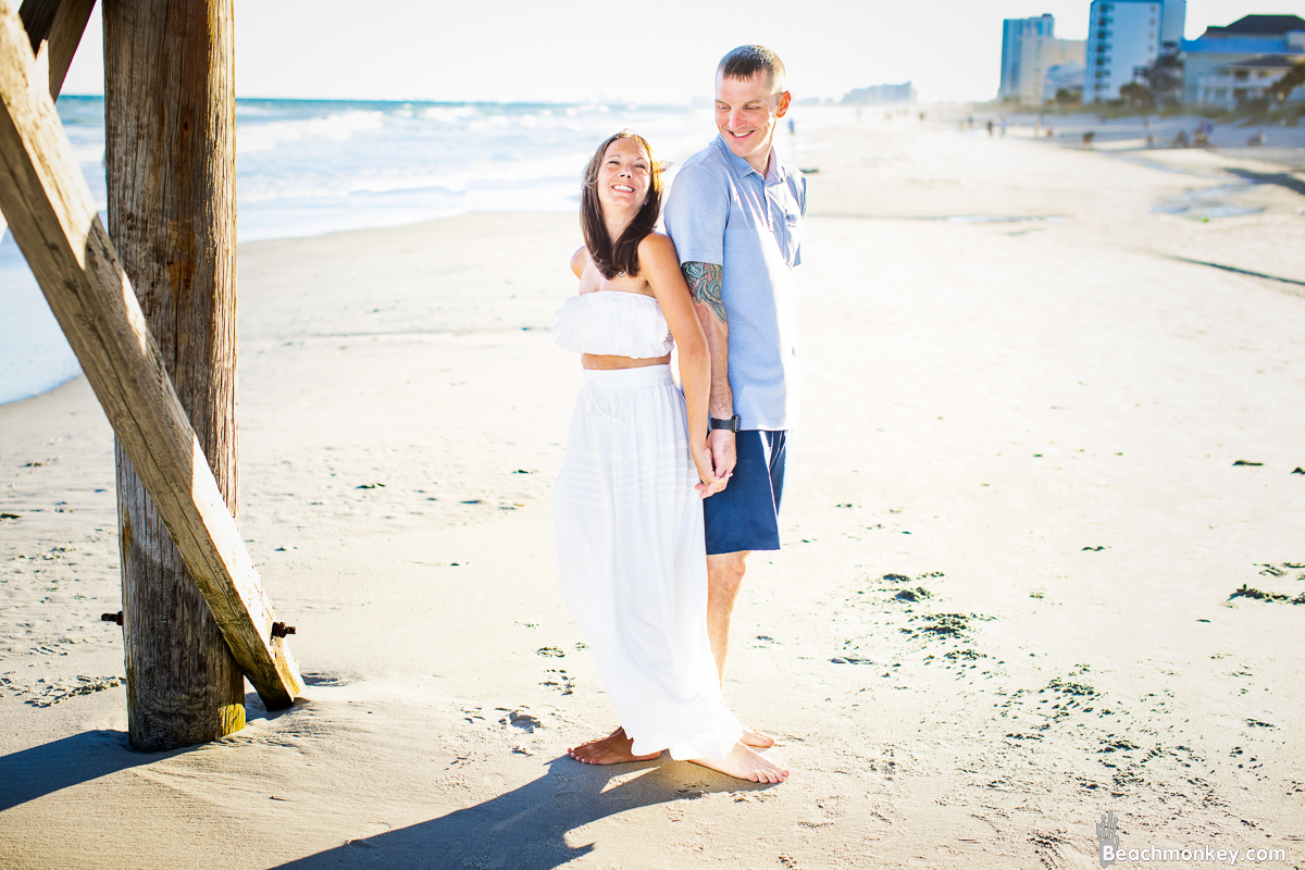 couple looking at each other couple kissing A family Beach photo shoot in North Myrtle Beach, SC with Amanda's family by Beachmonkey of beachmonkey photography, a family photographer on August 8th 2022