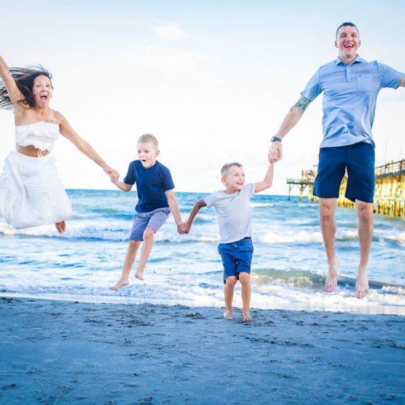 couple kissing A family Beach photo shoot in North Myrtle Beach, SC with Amanda's family ﻿ by Beachmonkey of beachmonkey photography, a family photographer on August 8th 2022