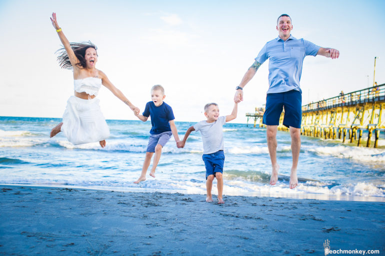 couple kissing A family Beach photo shoot in North Myrtle Beach, SC with Amanda's family by Beachmonkey of beachmonkey photography, a family photographer on August 8th 2022