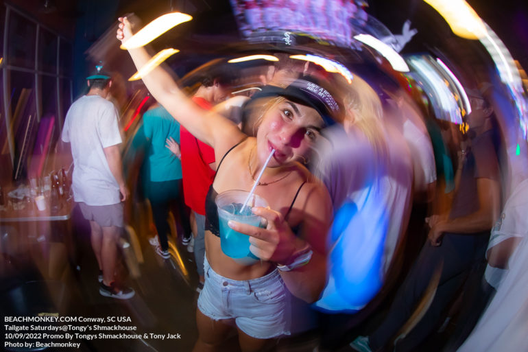 girl drinking and dancing in a large crowd at Tongy's Shmackhouse for Tailgate Saturdays on September 10th 2022 in Conway, SC USA photos by Myrtle Beach photographer Beachmonkey