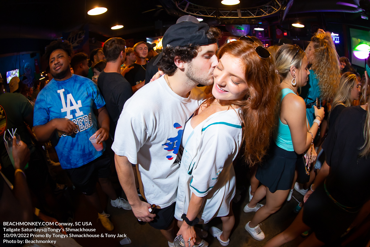 girl getting kiss from guy at Tongys Shmackhouse for Tailgate Saturdays Sept 10th 2022 in Conway, SC USA photos by Myrtle Beach photographer Beachmonkey