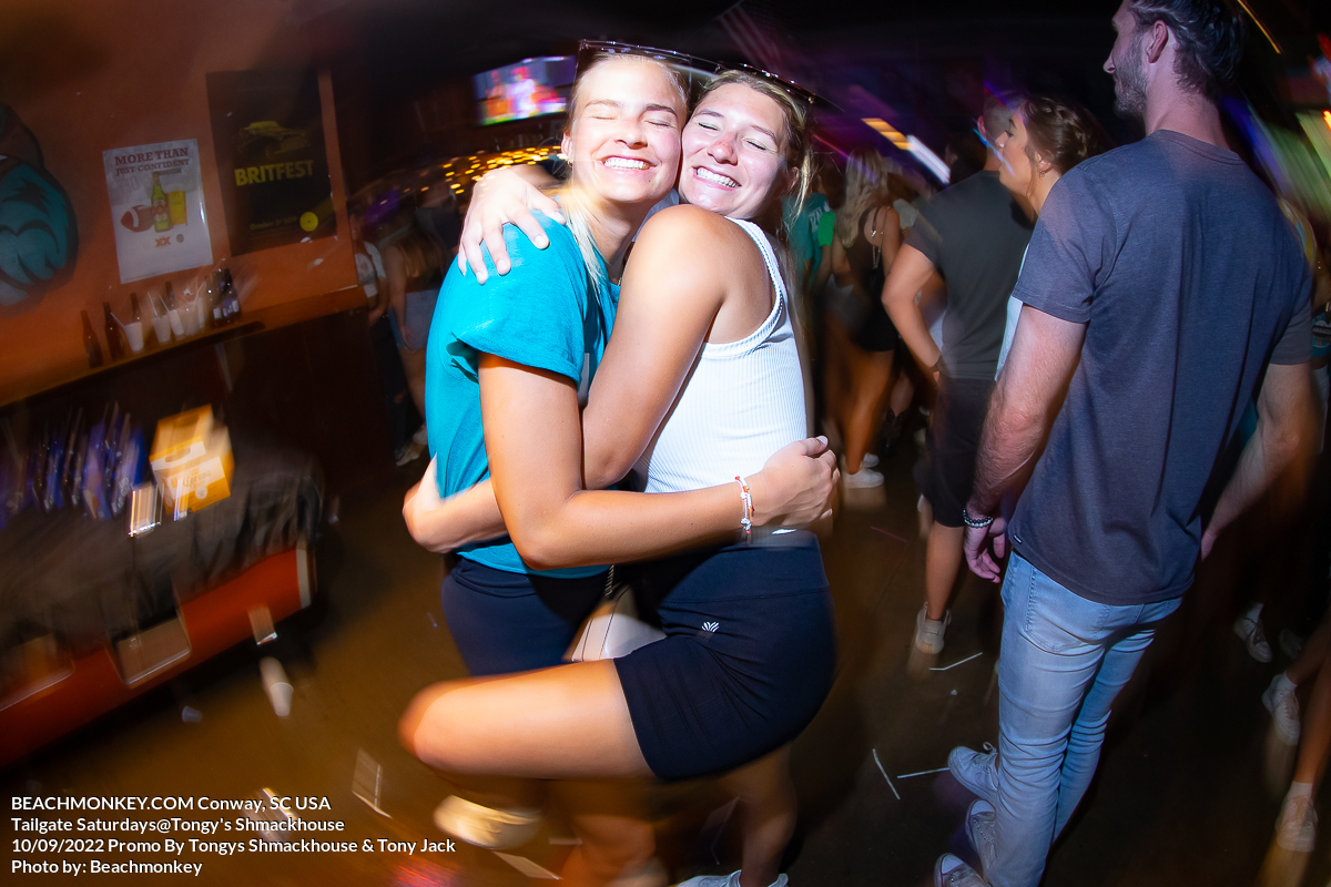 two hot girls hugging at Tongys Shmackhouse for Tailgate Saturdays Sept 10th 2022 in Conway, SC USA photos by Myrtle Beach photographer Beachmonkey