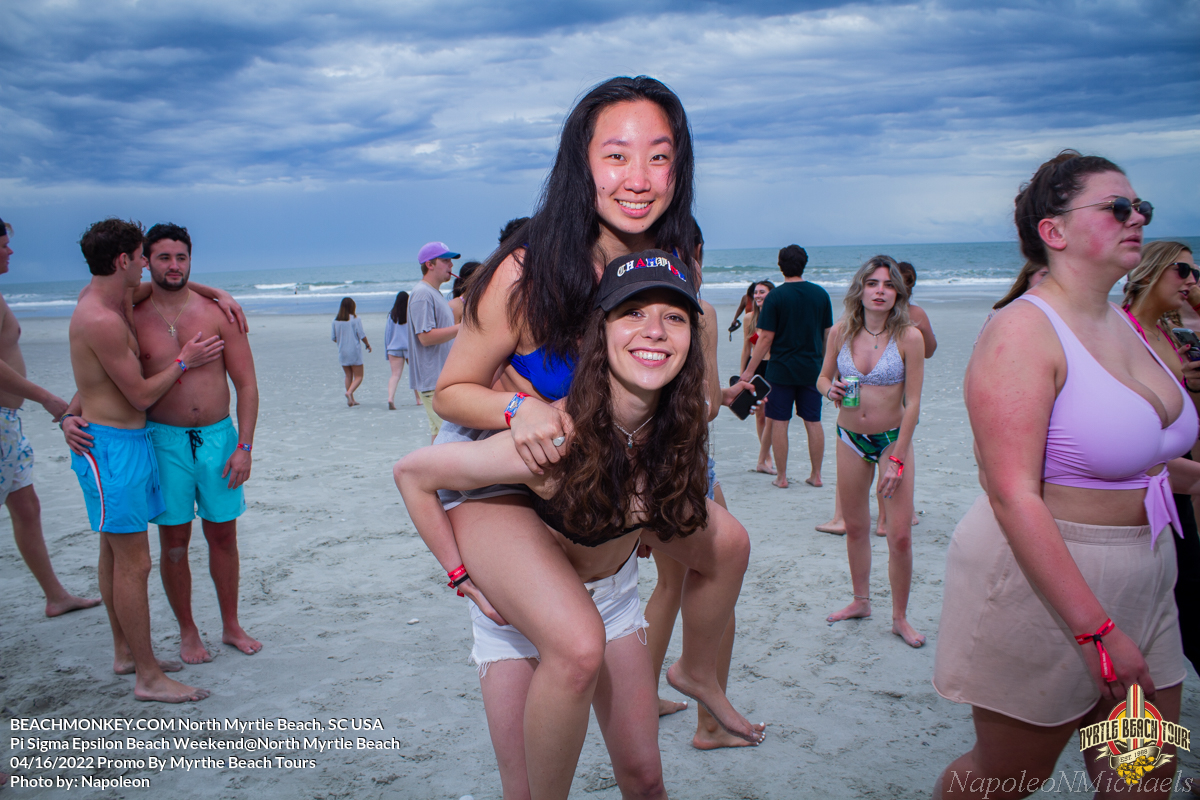 girl riding piggy back Pi Sigma Epsilon Fraternity Beach Weekend in North Myrtle Beach, SC USA sponsored by Myrtlebeachtours.com April 16th 2022 Photos by Napoleon